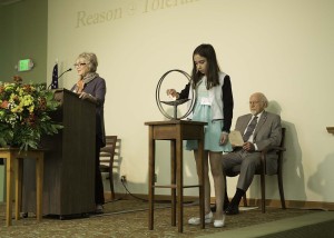 Ava Hensley lights the chalice. Photo/Kenny Gray